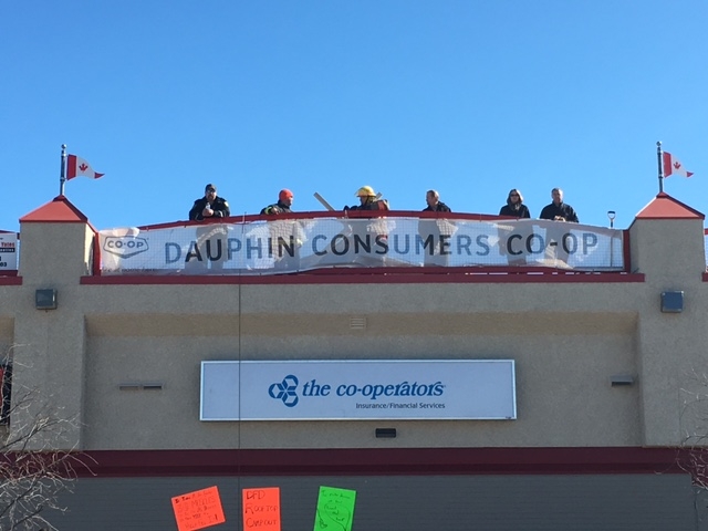 Members of the Dauphin Fire Department on top of the Dauphin Marketplace Mall