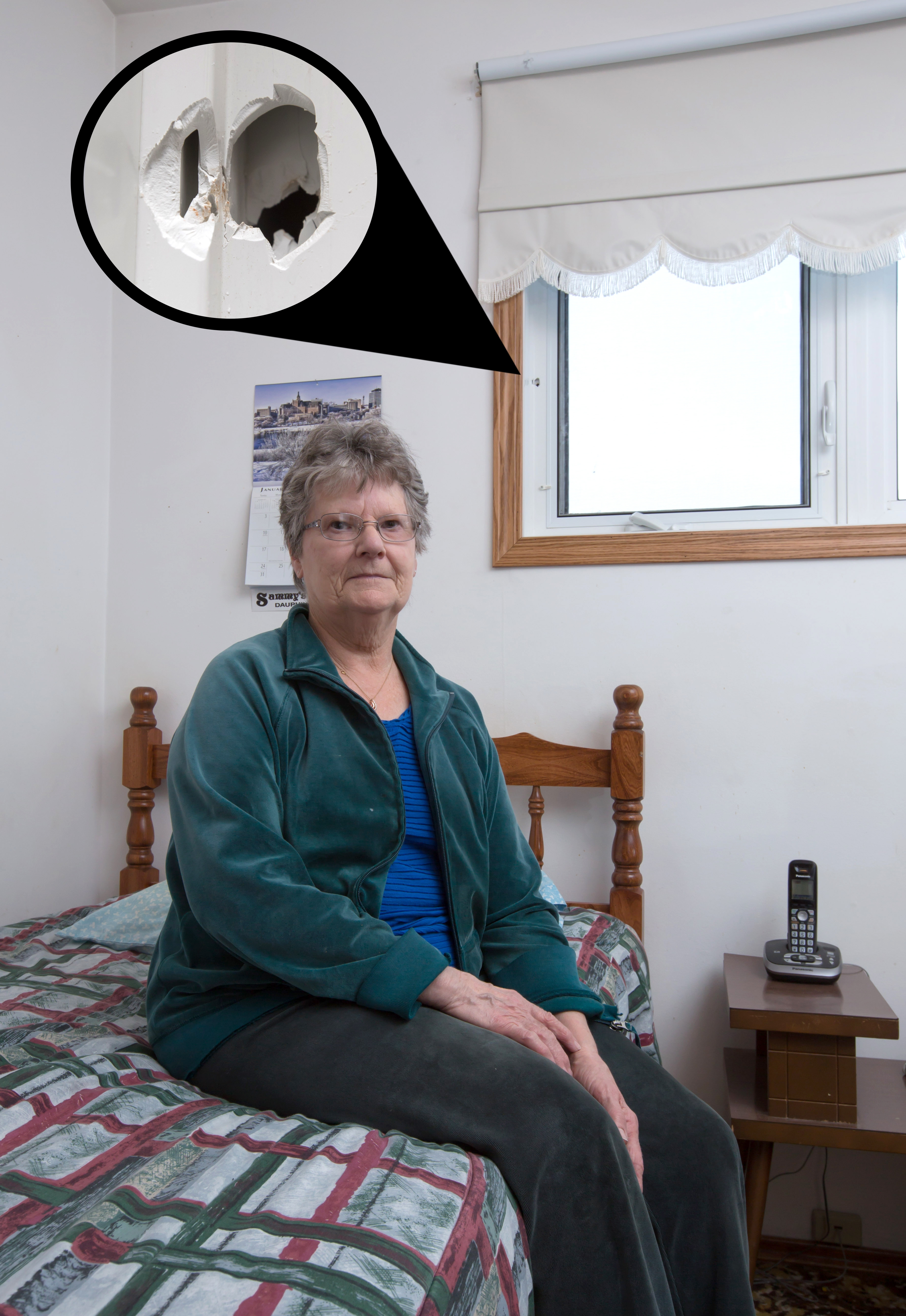 Doreen Sliworsky showing just how close the bullet hole was to her. Photo Credit: Fred Greenslade, Manitoba Wildlife Federation